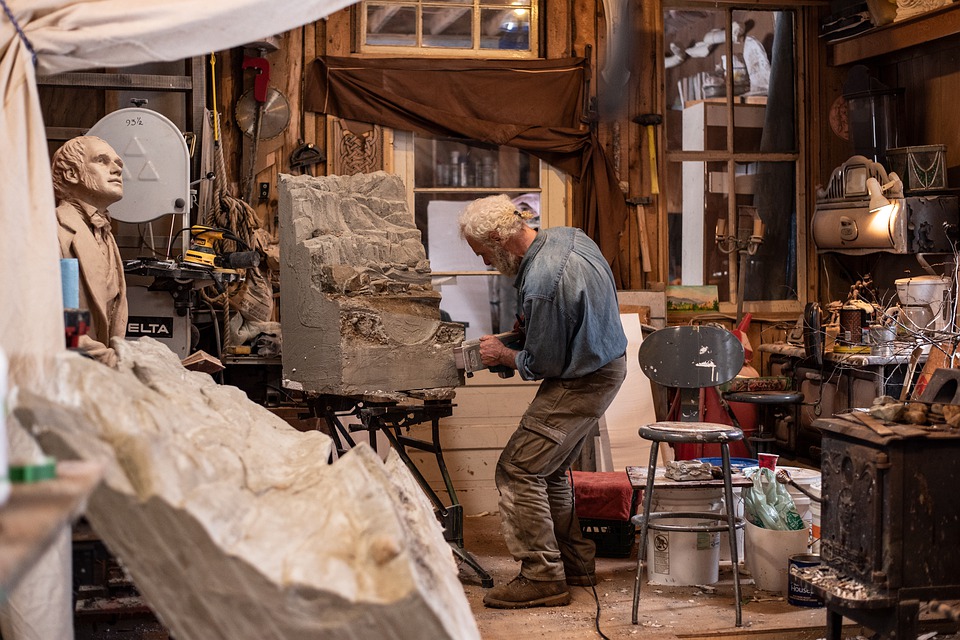 man sculpting in his workshop