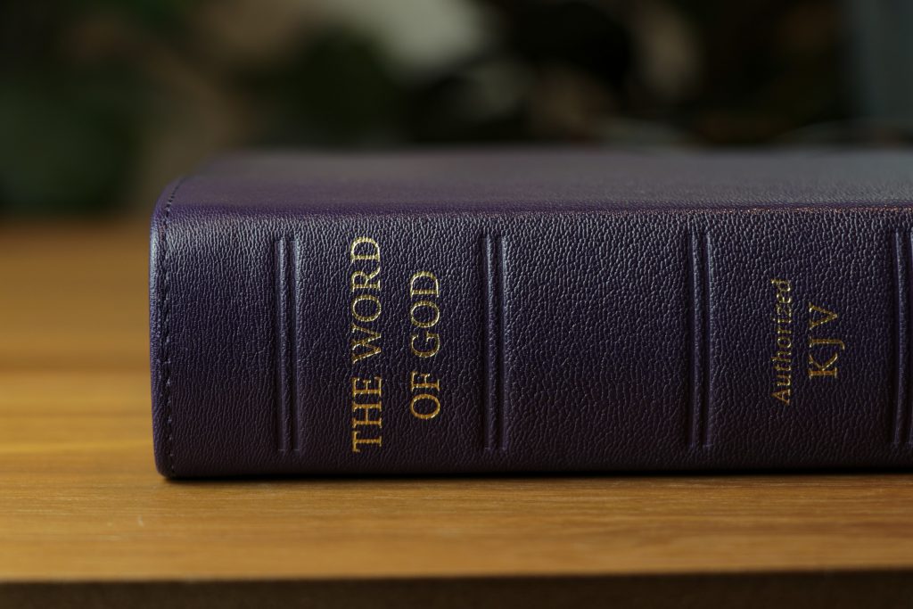 A Bible lying on a table reads on the spine, "The Word of God: Authorized KJV"