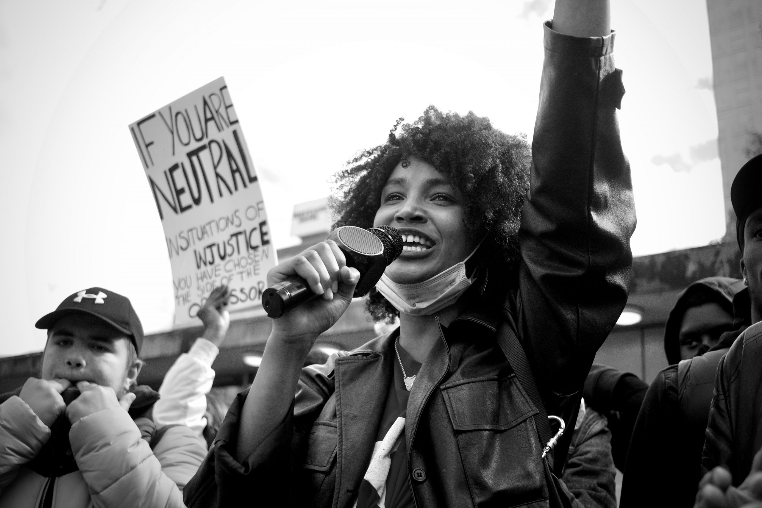 woman protests in a crowd against injustice
