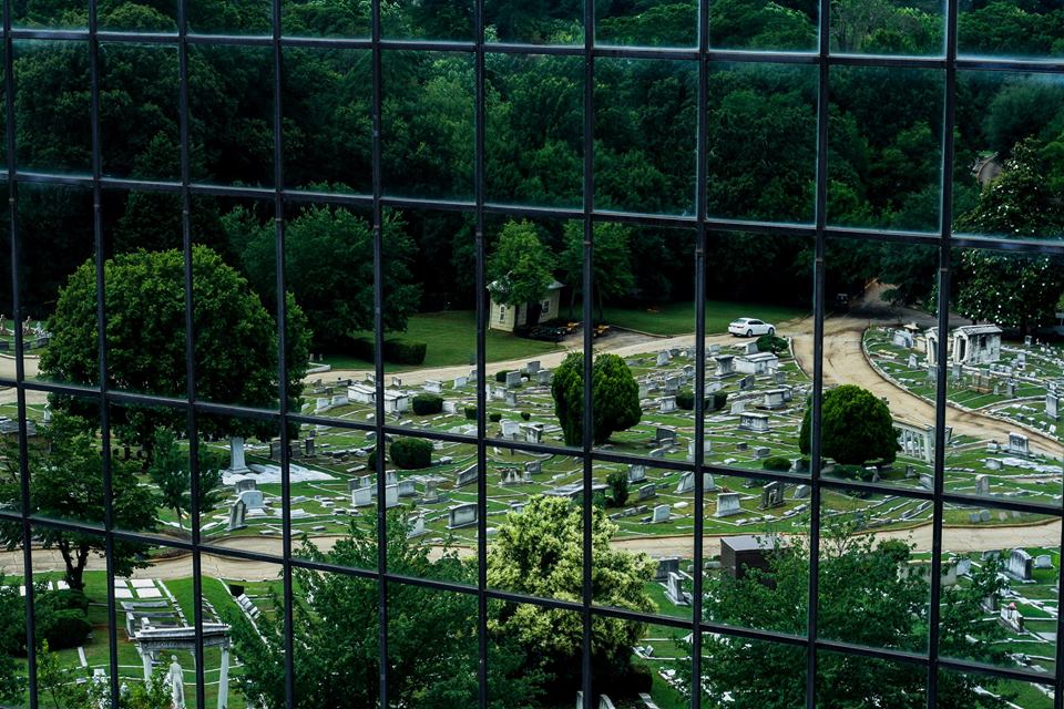 view of a graveyard through a fence