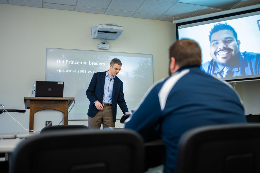 professor teaches a class to students in person and via livestream