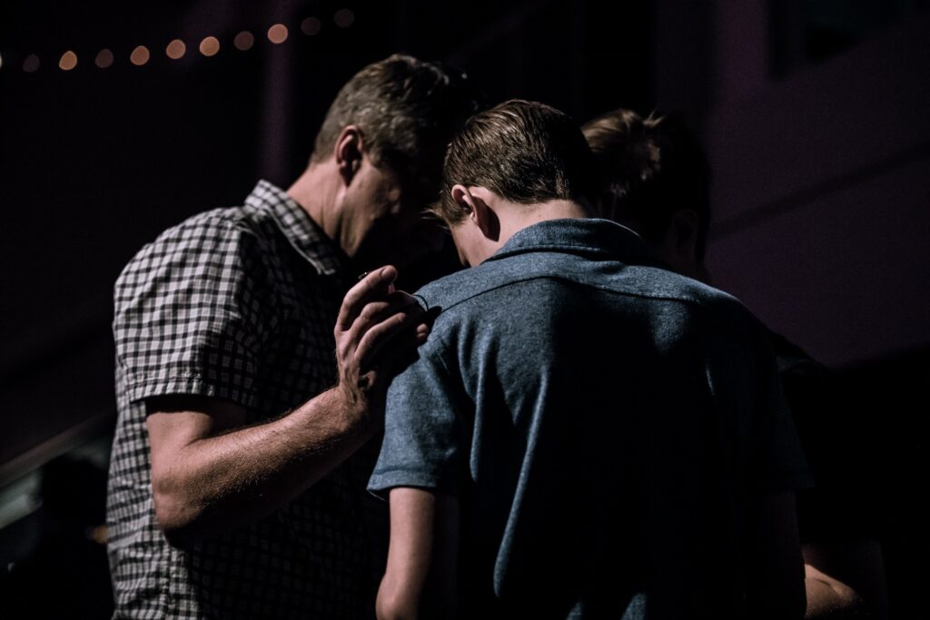 men pray together